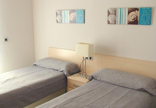 The second bedroom The second bedroom has 2 single beds and a bedside table. The bedsheets are included.
